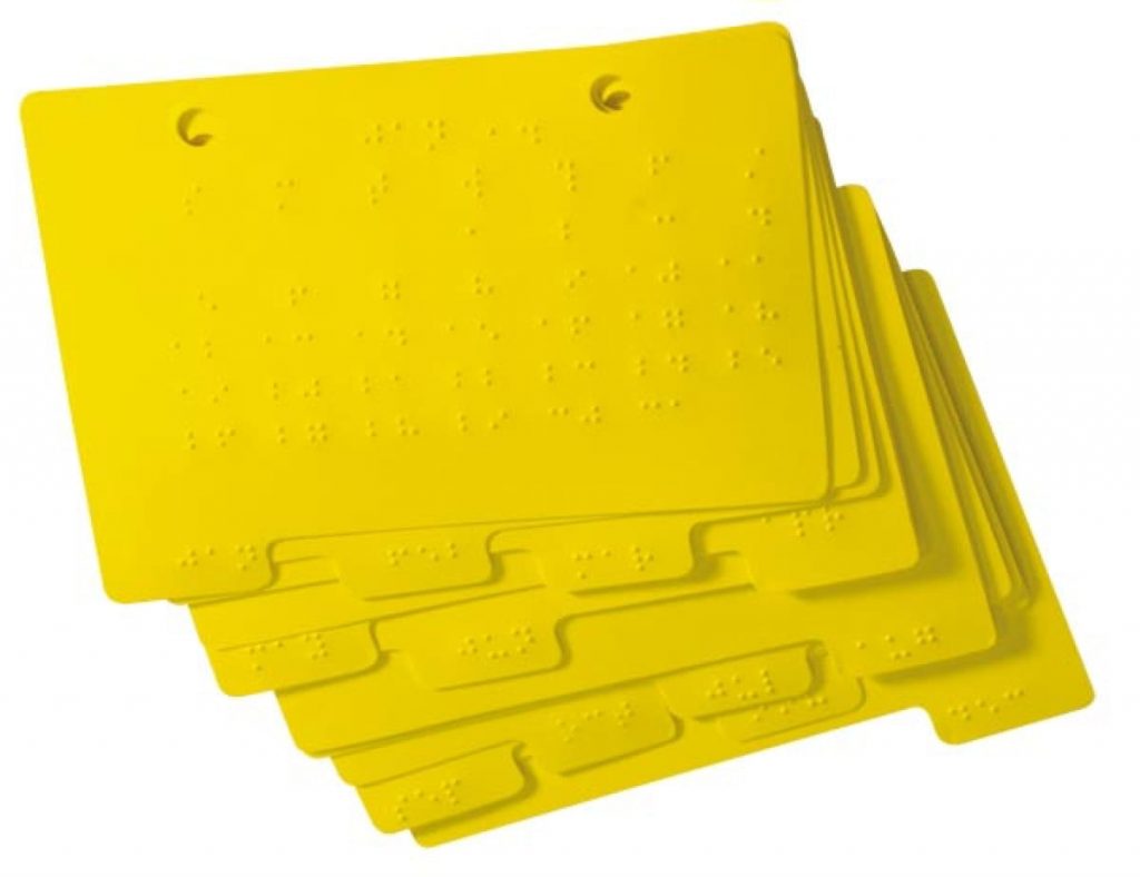 A stack of tabbed yellow Braille DateBook calendar pages.