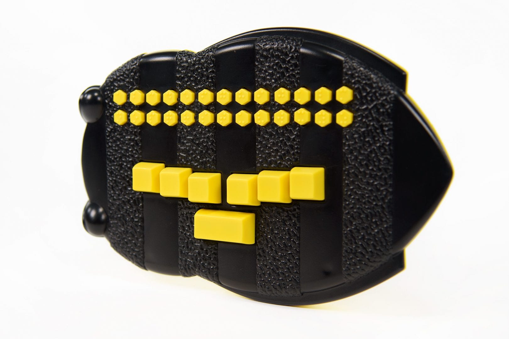 Photo of the Braille Buzz. The unit is bee-shaped black plastic with bright yellow buttons.