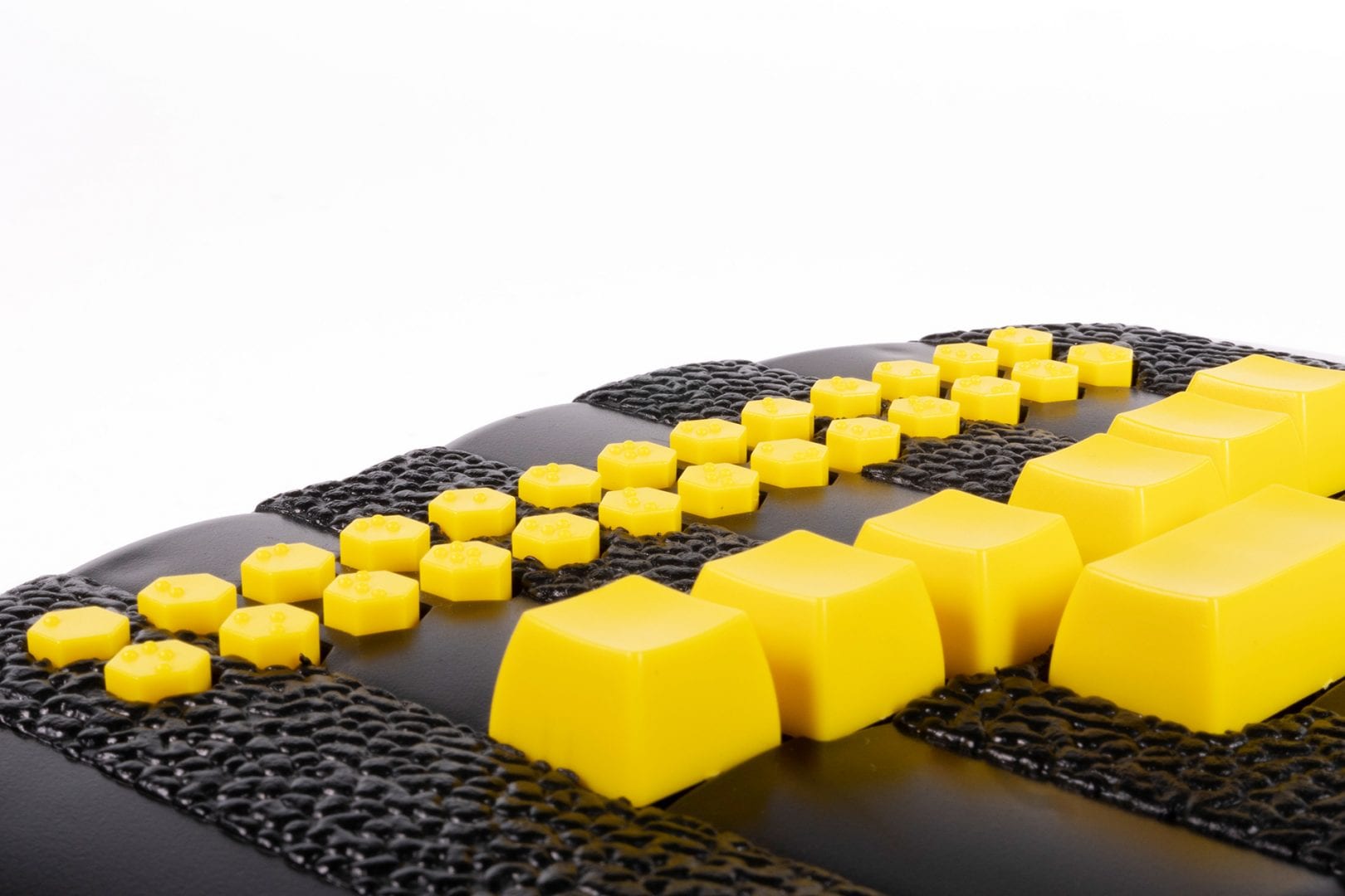 close-up photo of the Braille Buzz and its bright yellow buttons