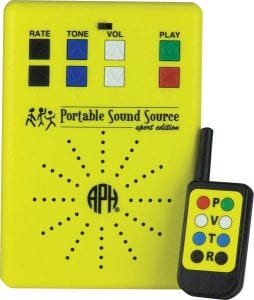 yellow sound source with black, blue, white, green, and red buttons. The black and yellow remote sits next to it with corresponding buttons.