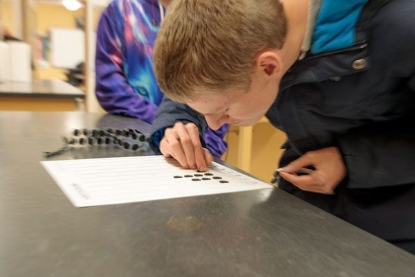 Student making a frequency diagram with the histogram board.