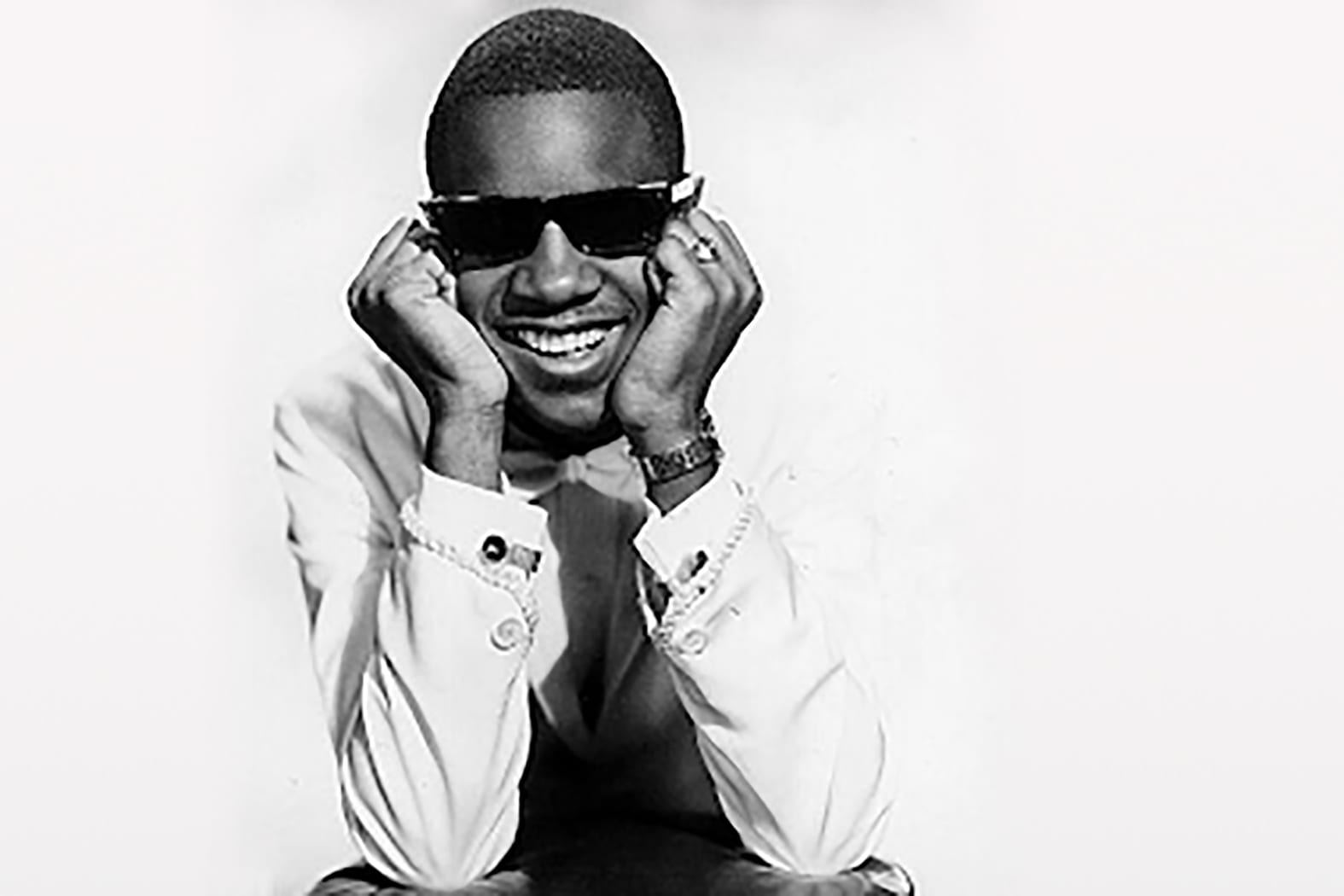 young Stevie Wonder with his head resting in his hands