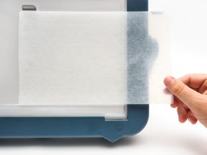 Hand placing Dycem on Mini Lite Box