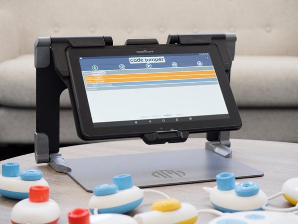Code Jumper’s hub and colorful pods are connected to the MATT Connect with the Code Jumper app and a thread of code displayed on the tablet’s screen.