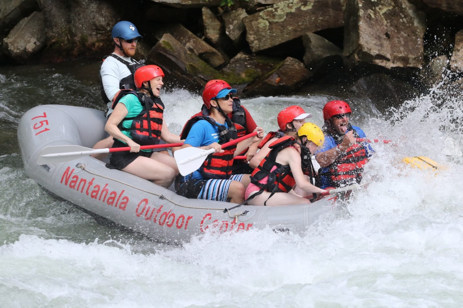 Campers enjoy navigating their raft through white water rapids