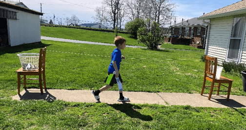 a child running from one chair to the other along the lead line