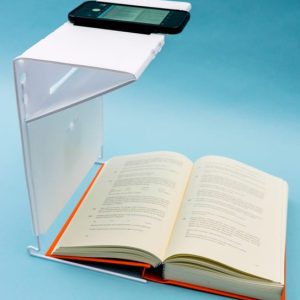 A smartphone with KNFB Reader on the portable stand above an open book