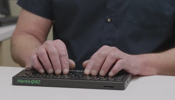 Close up of user typing on the Mantis Q40