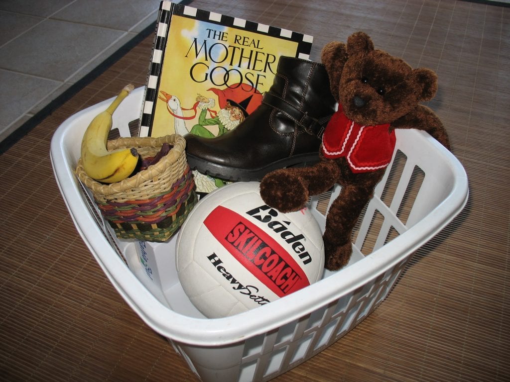 a laundry basket filled with "b" word items like bear and ball