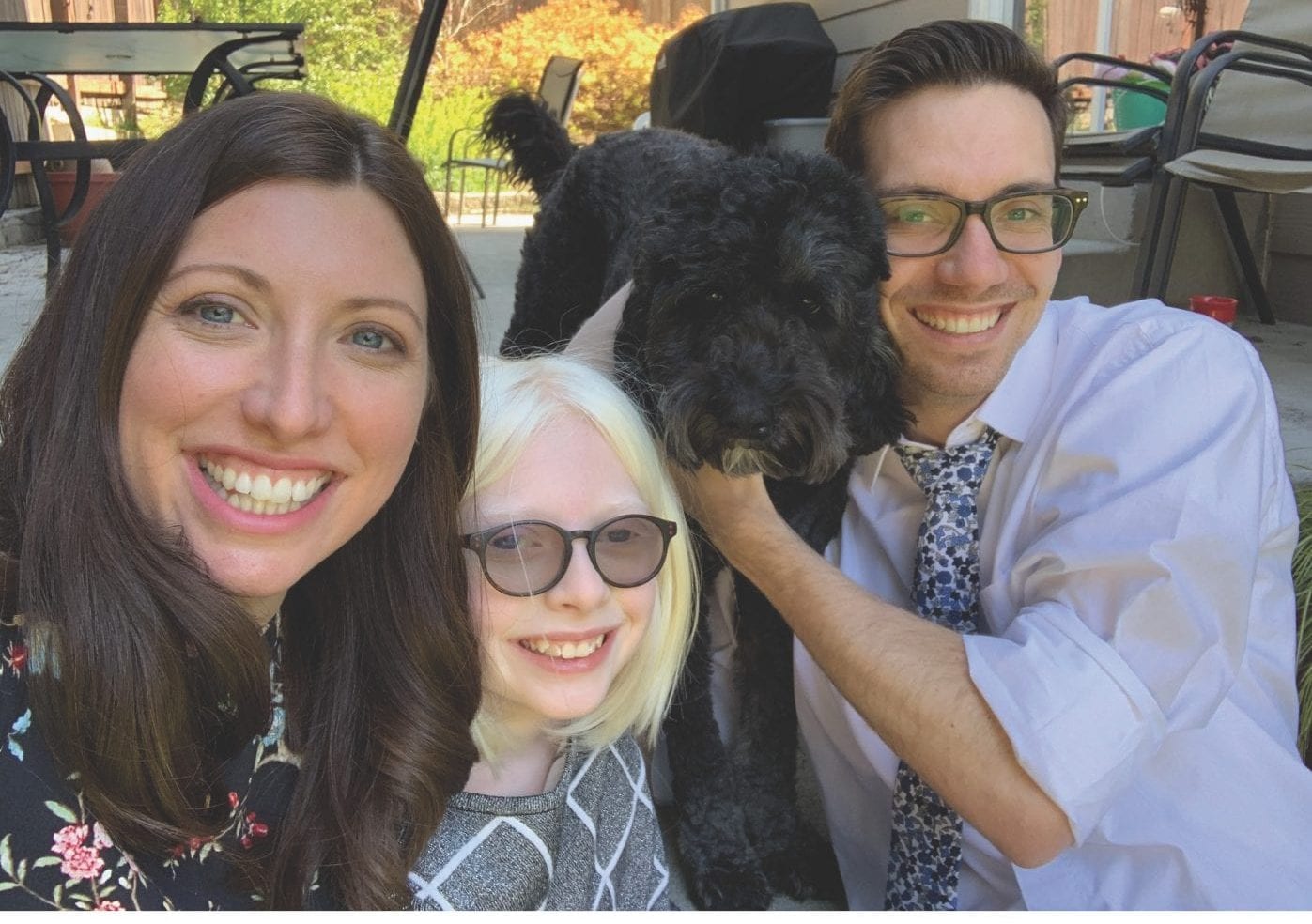 a photo of Maghan, Kaitlin, Tyler, and their dog