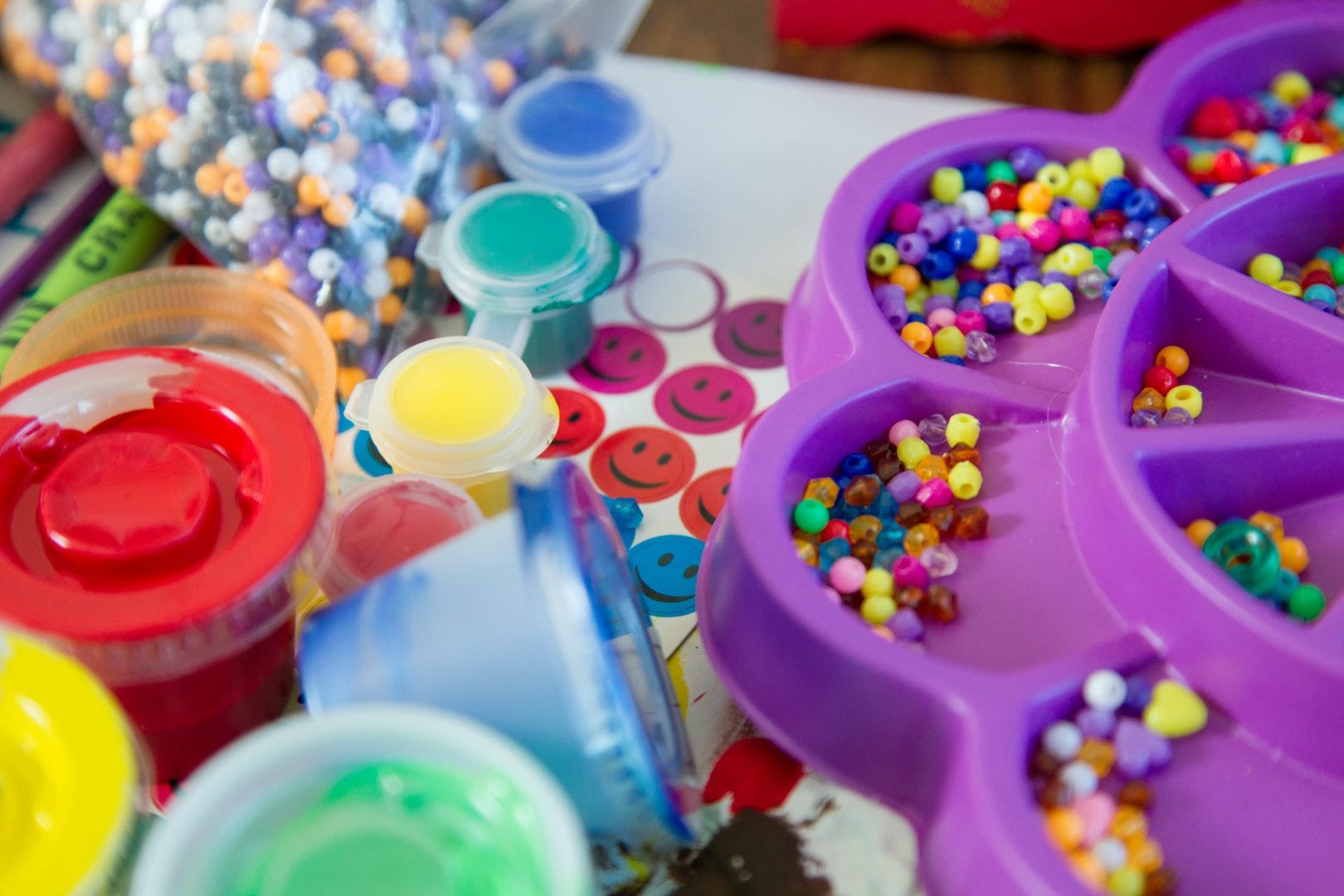 a variety of craft decorations including beads, paint, and stickers