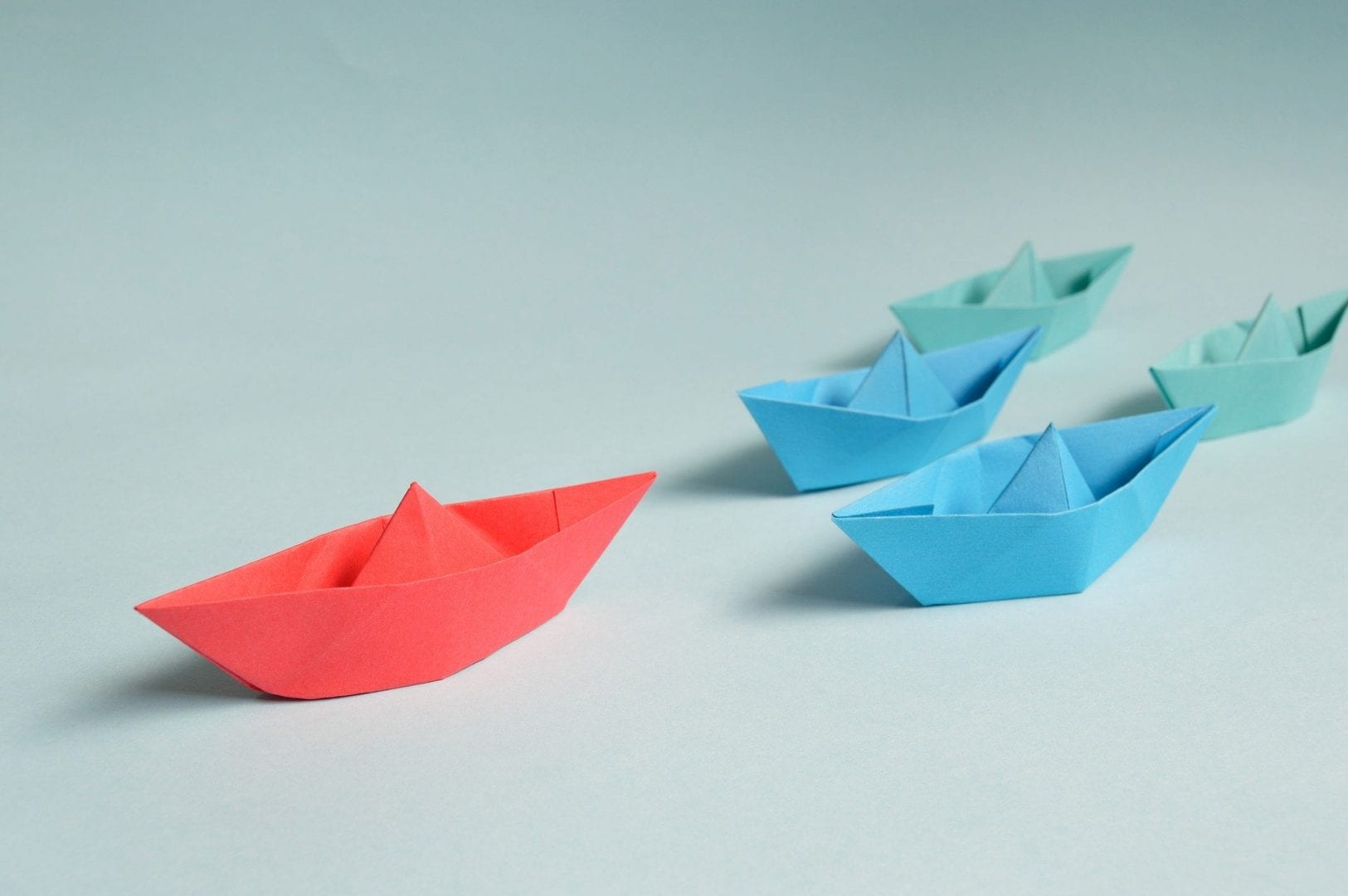 paper boats on a light blue background