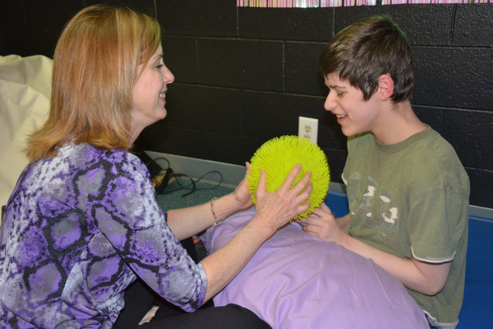 A learner begins to imitate his teacher during a Sensory Learning Kit play routine.