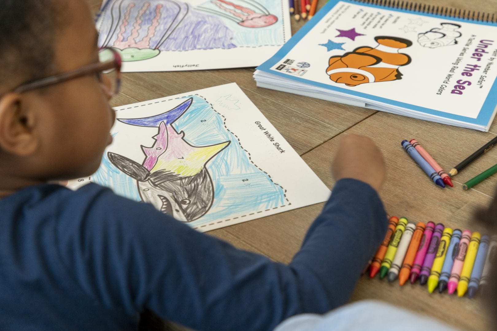 student coloring a Paint by Number Safari coloring page