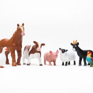 a row of a plastic 3-D animal miniatures including a duck, horse, cow, pig, sheep, goat, and a rooster.