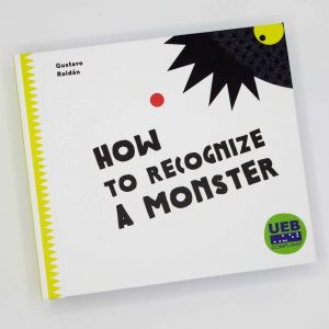 How to Recognize a Monster by Gustavo Roldán. Cover of the book shows a black spiky haired monster barley poking his head out of the top right-hand corner.