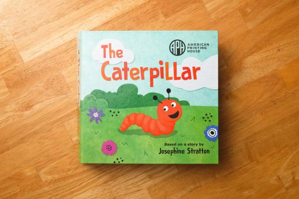 The Caterpillar book based on a story by Josephine Stratton. Front cover illustration shows the orange caterpillar crawling across a bright green field with flowers and bushes and a blue sky.