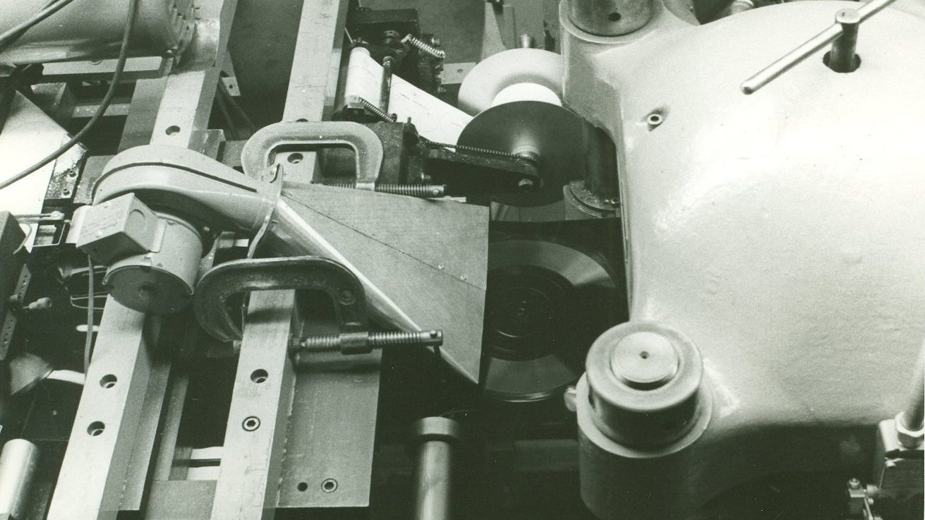 View from above as a pressed disk emerges from the flexible record press.